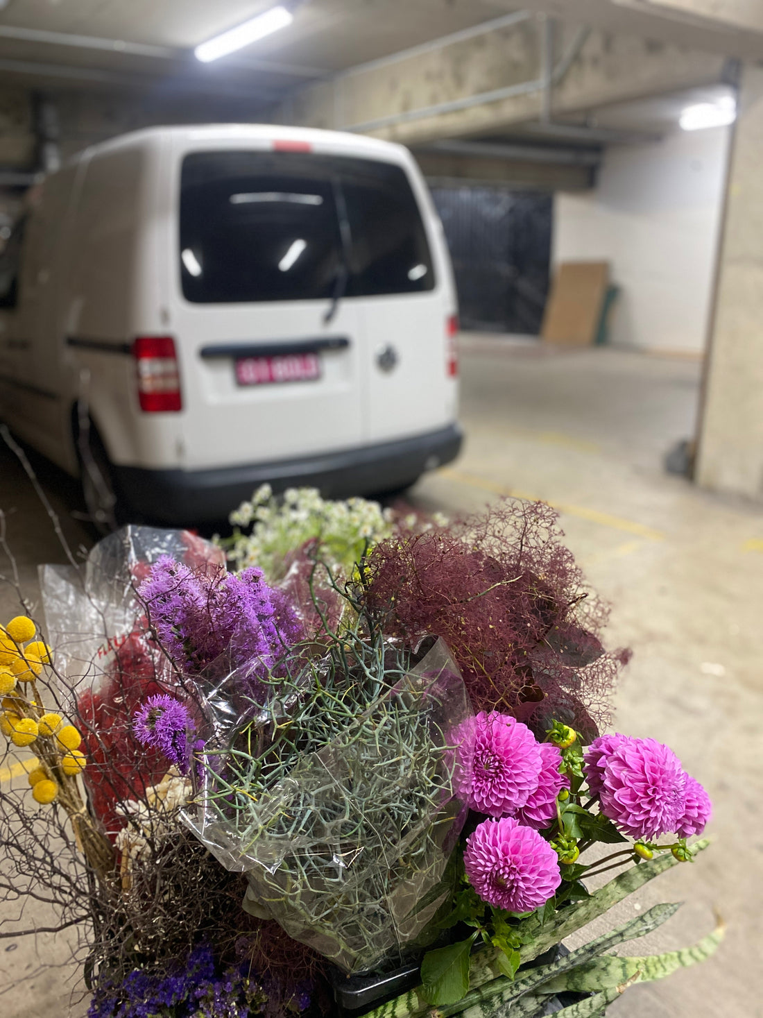 Bold Botanicals van in bacground, with fresh flower deliveries in the foreground